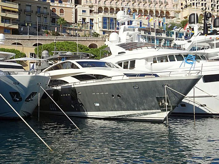 several boats docked in a harbor aboard APMONIA Yacht for Sale