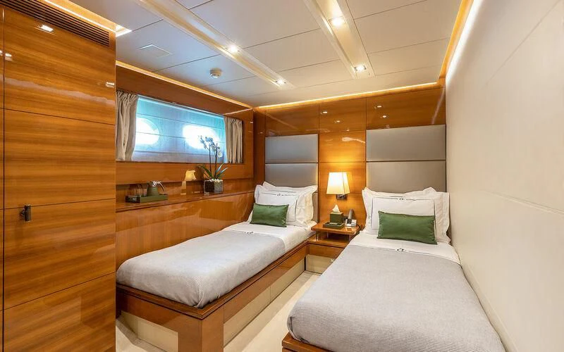 a room with two beds aboard APMONIA Yacht for Sale