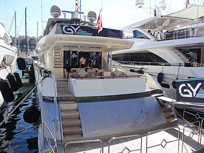 a boat docked with other boats aboard APMONIA Yacht for Sale