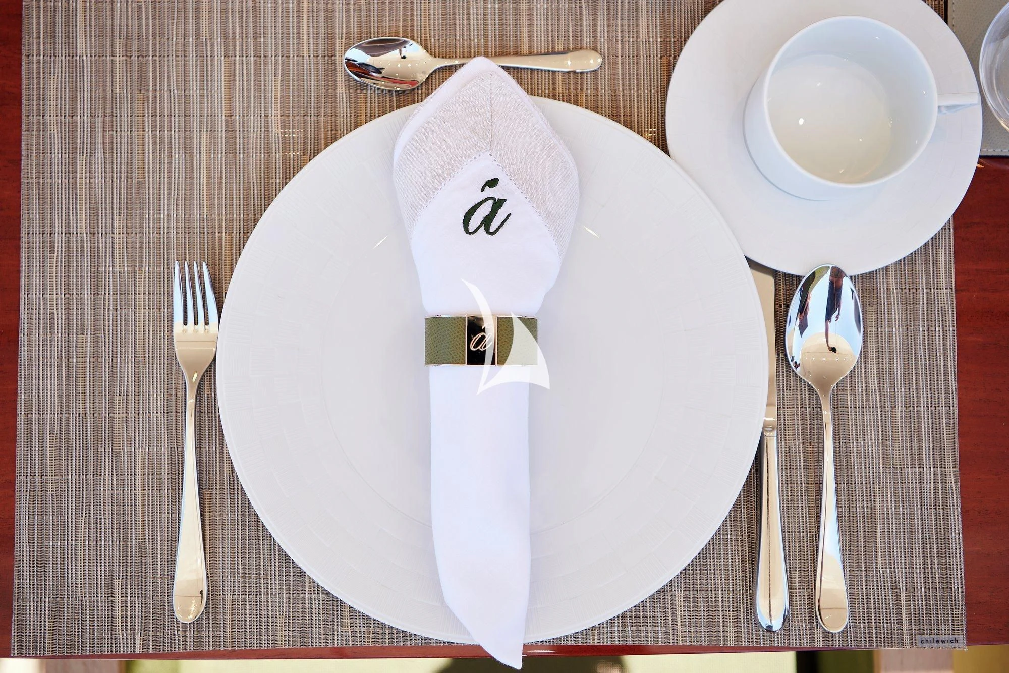 a white plate with a face on it and silverware on it aboard APMONIA Yacht for Sale