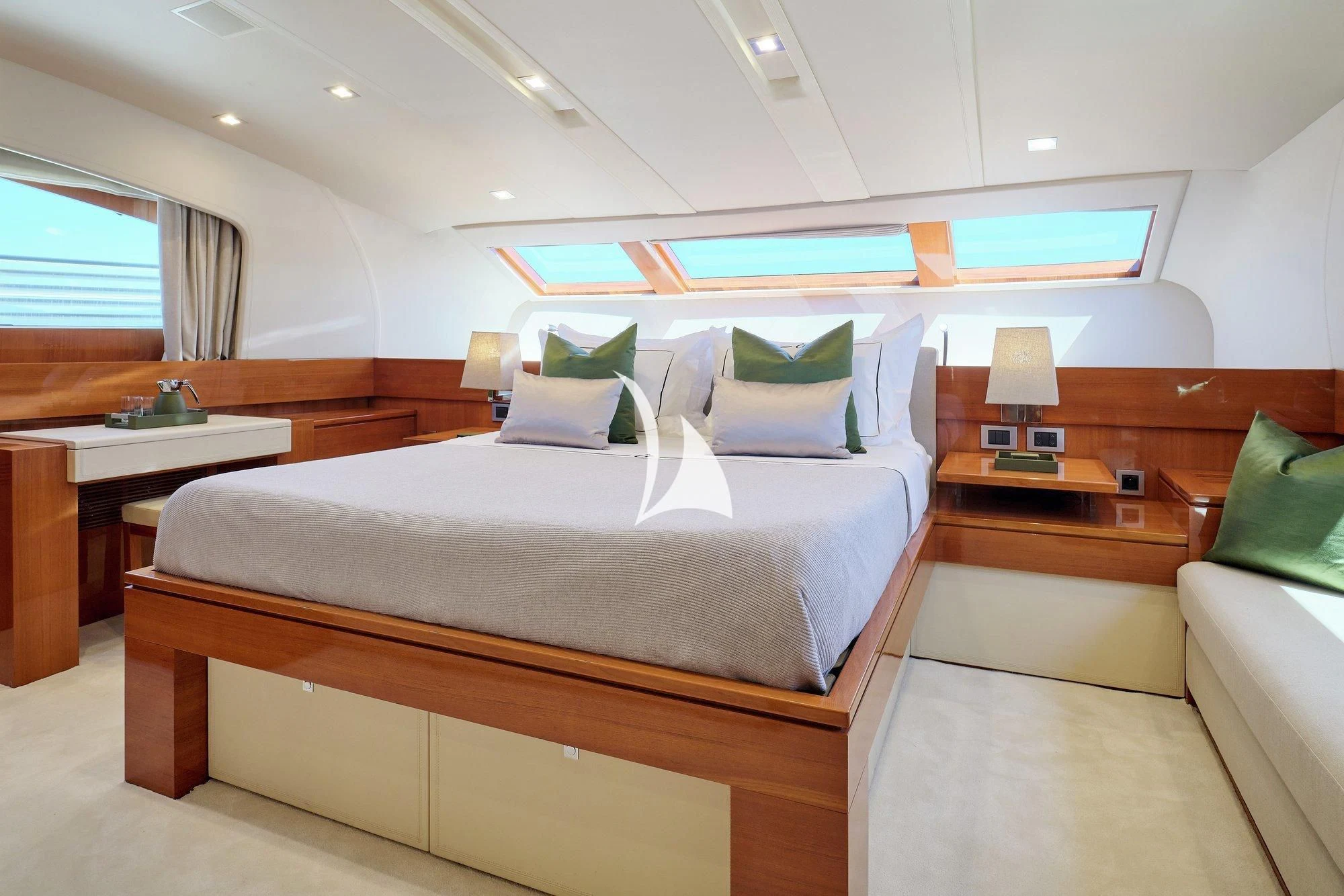a room with a bed and desk aboard APMONIA Yacht for Sale