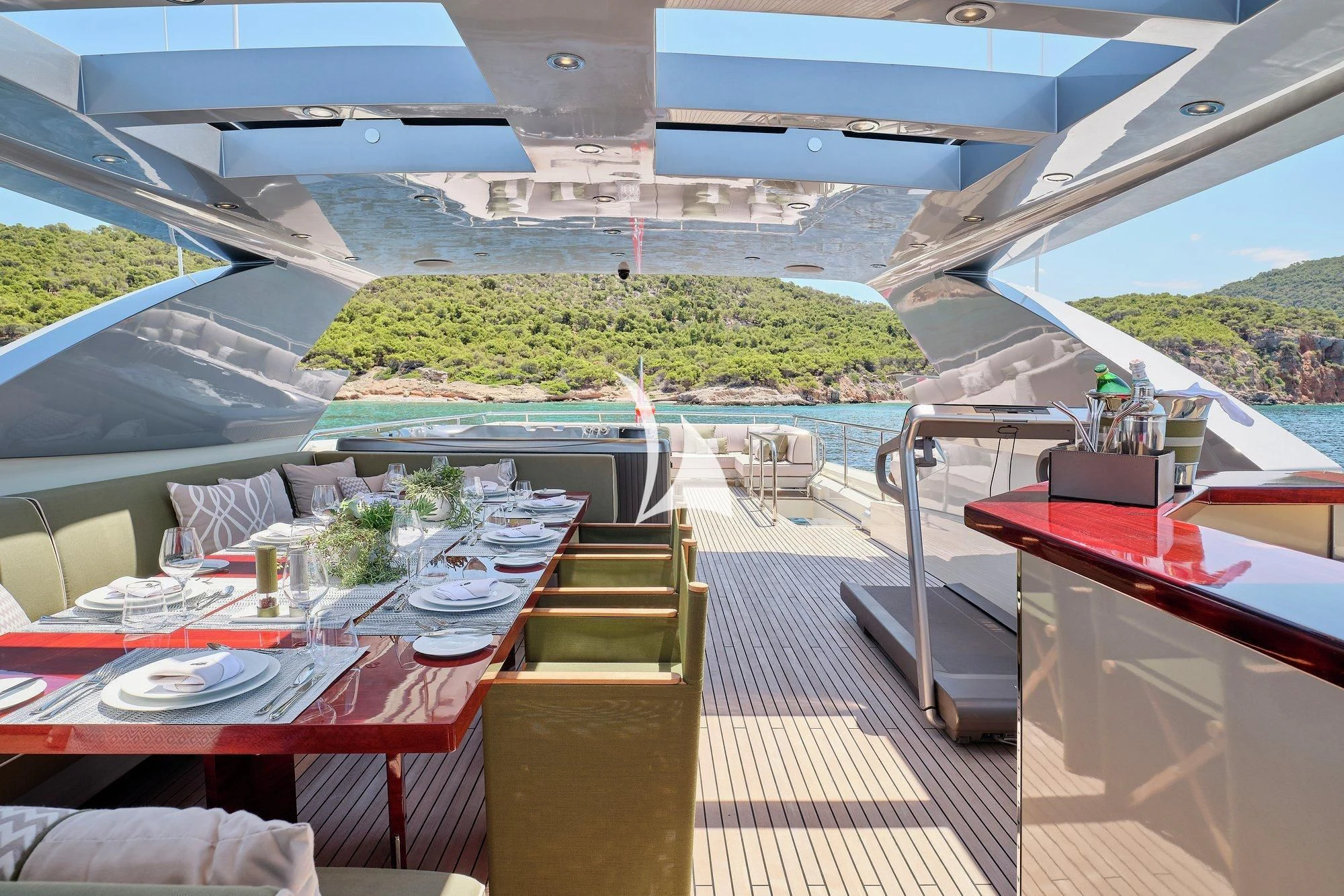 a deck with a table and chairs aboard APMONIA Yacht for Sale