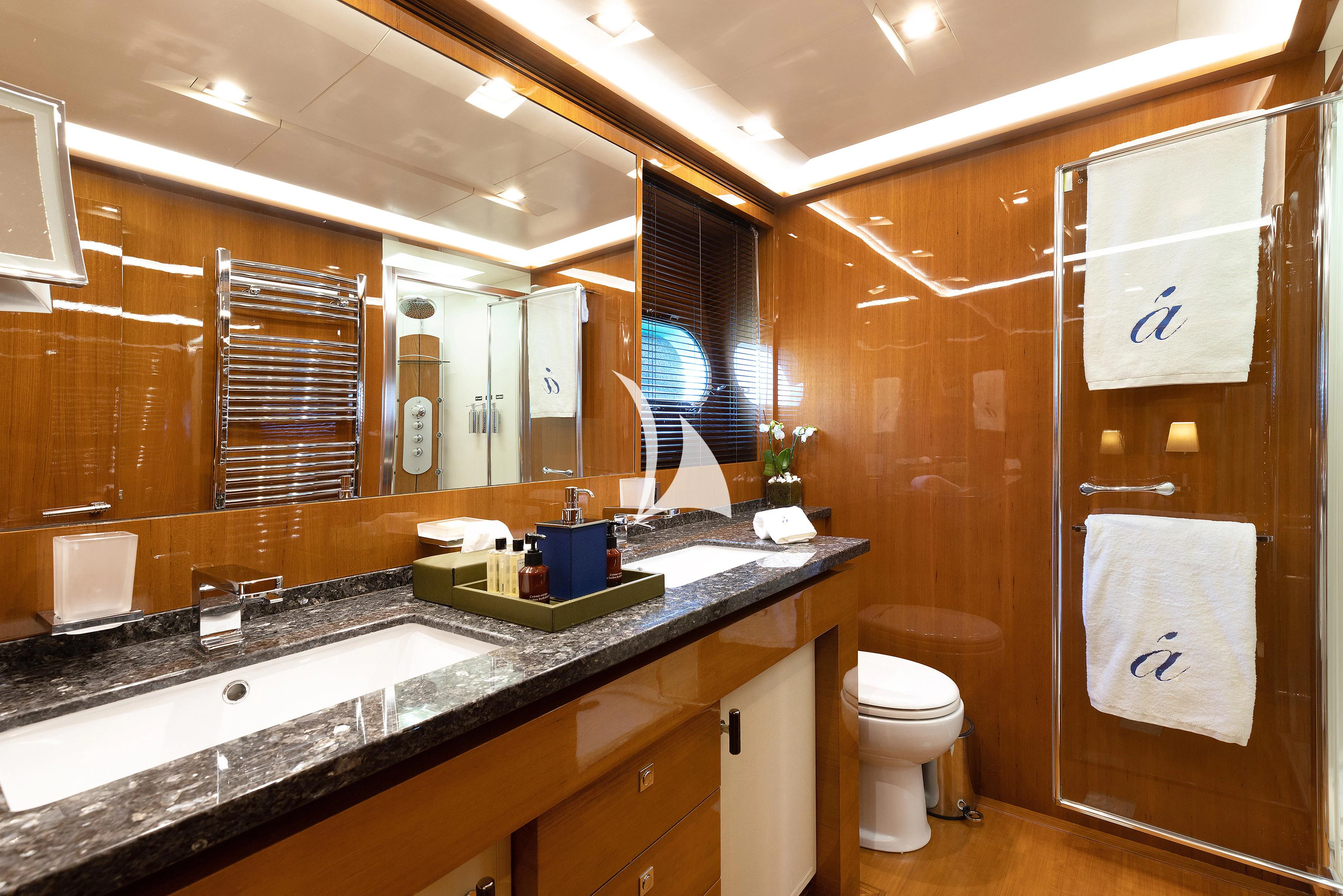 a bathroom with a large mirror aboard APMONIA Yacht for Sale