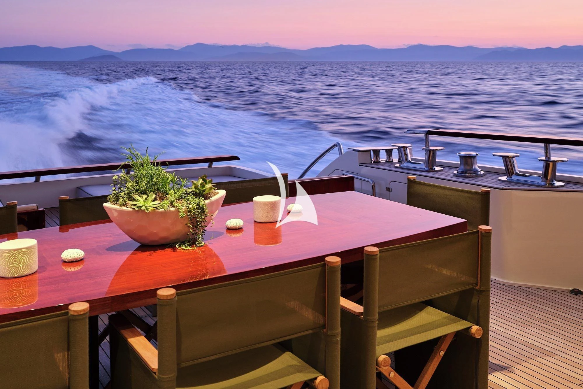 a table with a plant on it aboard APMONIA Yacht for Sale