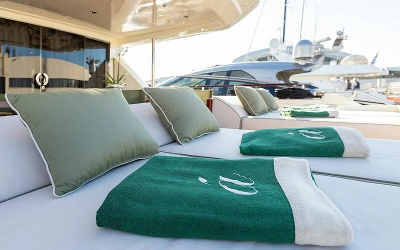 a room with a bed and a couple of pillows aboard APMONIA Yacht for Sale