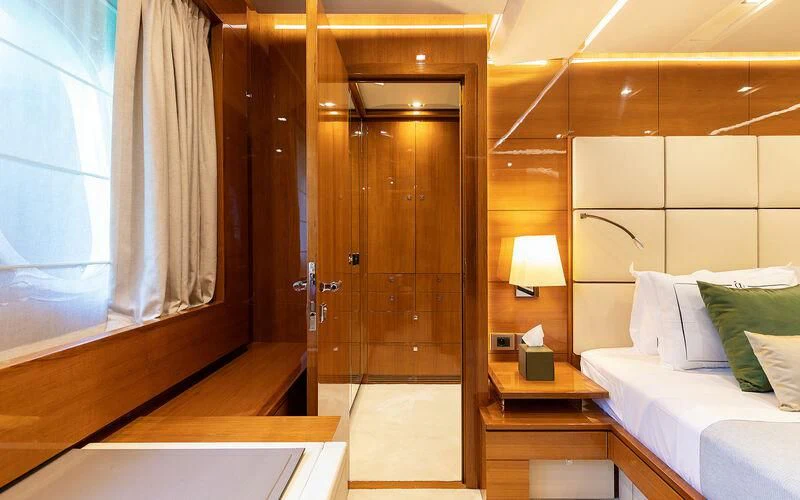 a room with a bed and a door aboard APMONIA Yacht for Sale