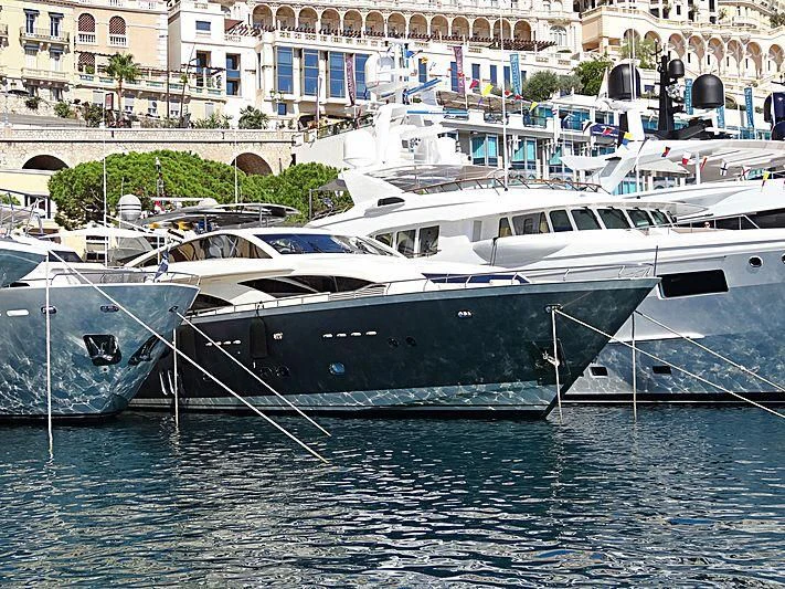 a group of boats are parked in a harbor aboard APMONIA Yacht for Sale