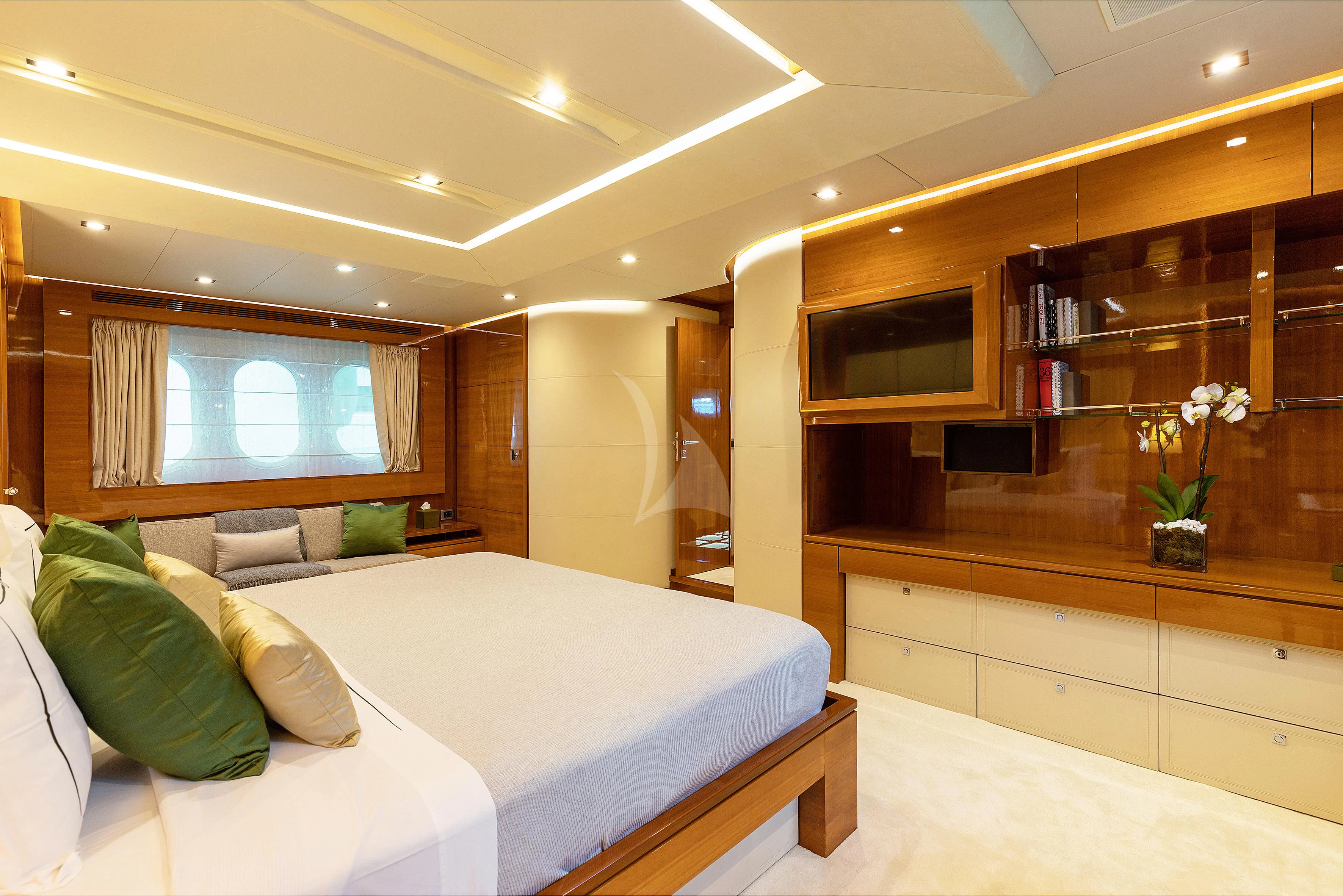 a room with a bed and a shelf with books on it aboard APMONIA Yacht for Sale