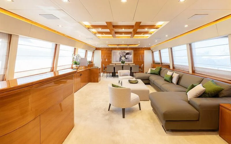 a living room with a couch and a coffee table aboard APMONIA Yacht for Sale