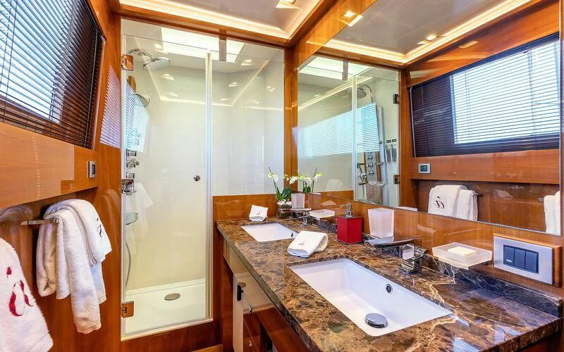 a bathroom with a countertop sink and mirror aboard APMONIA Yacht for Sale