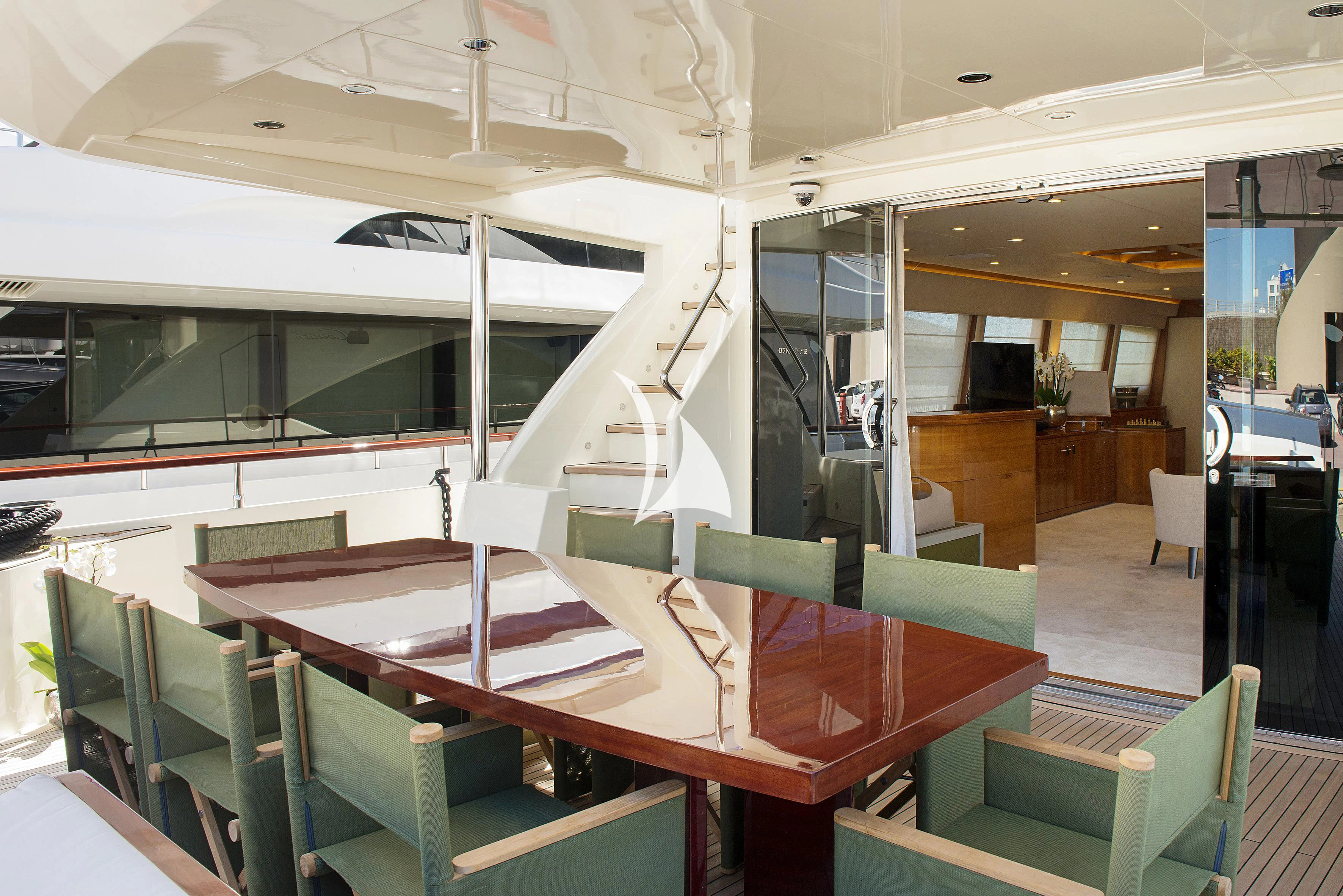 a room with tables and chairs aboard APMONIA Yacht for Sale