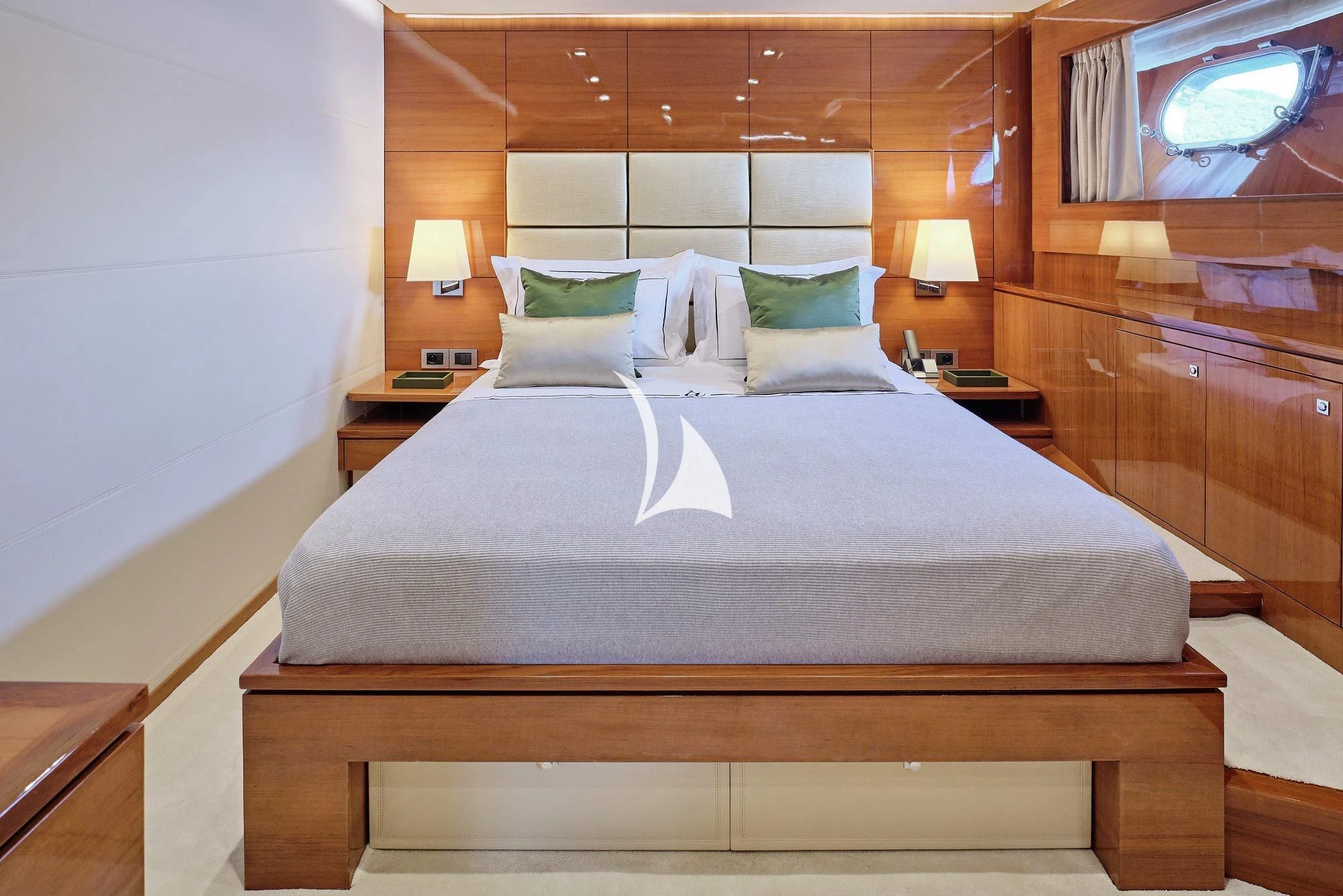 a bed with a white sheet and pillows on it aboard APMONIA Yacht for Sale