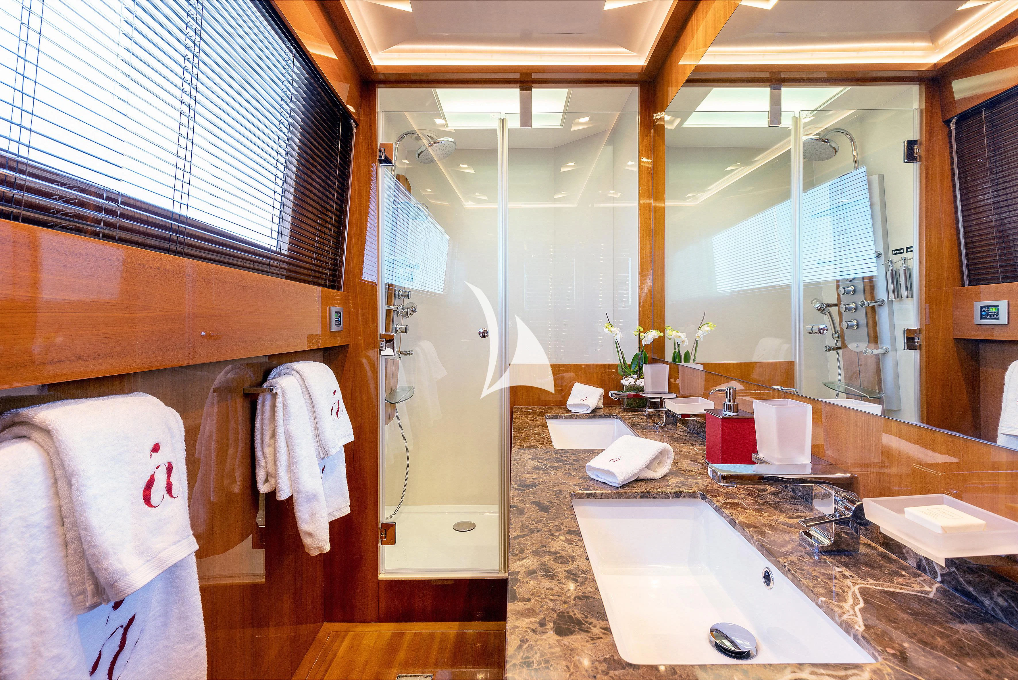 a bathroom with a large mirror aboard APMONIA Yacht for Sale