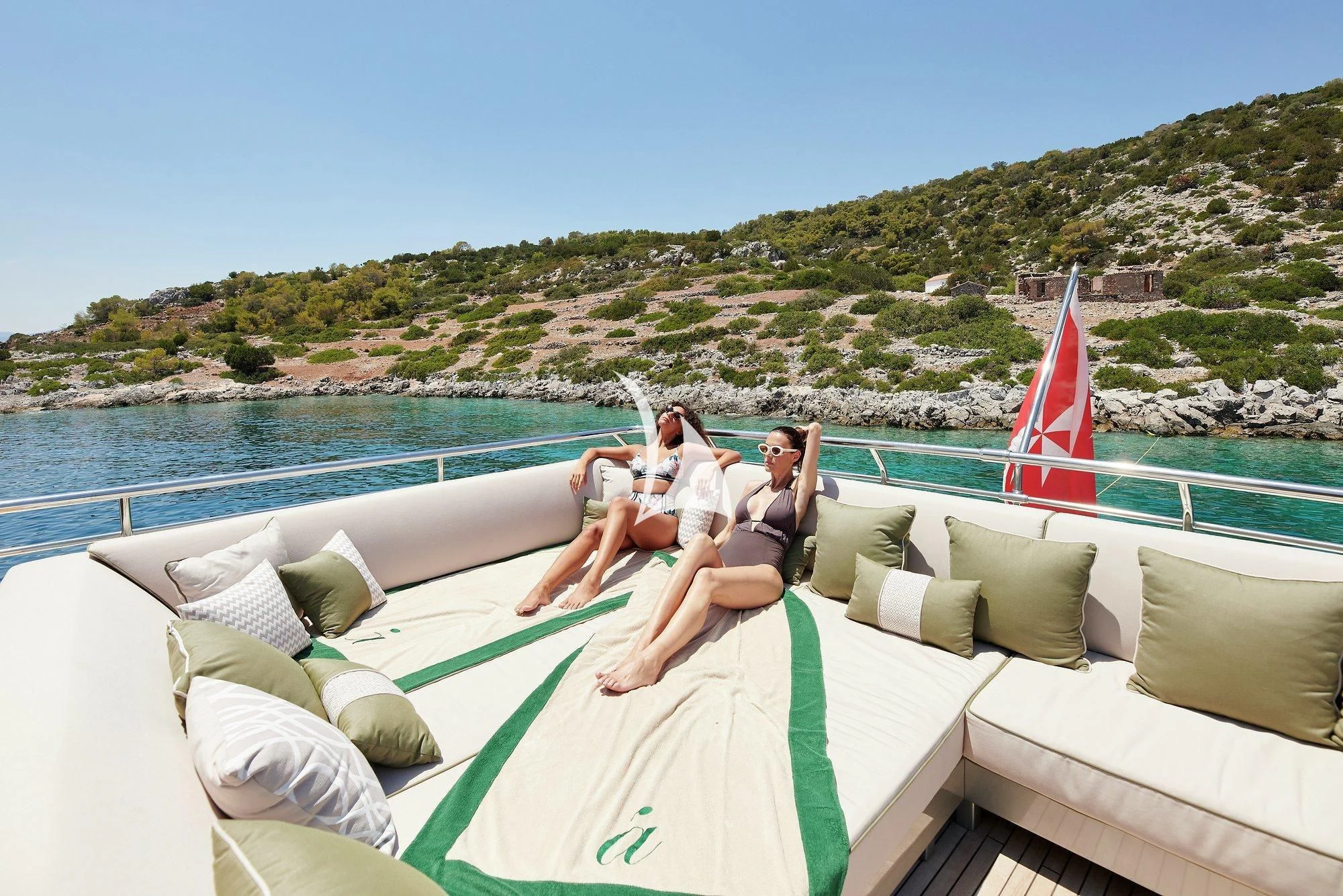 a group of people sitting on a lounge chair on a boat aboard APMONIA Yacht for Sale