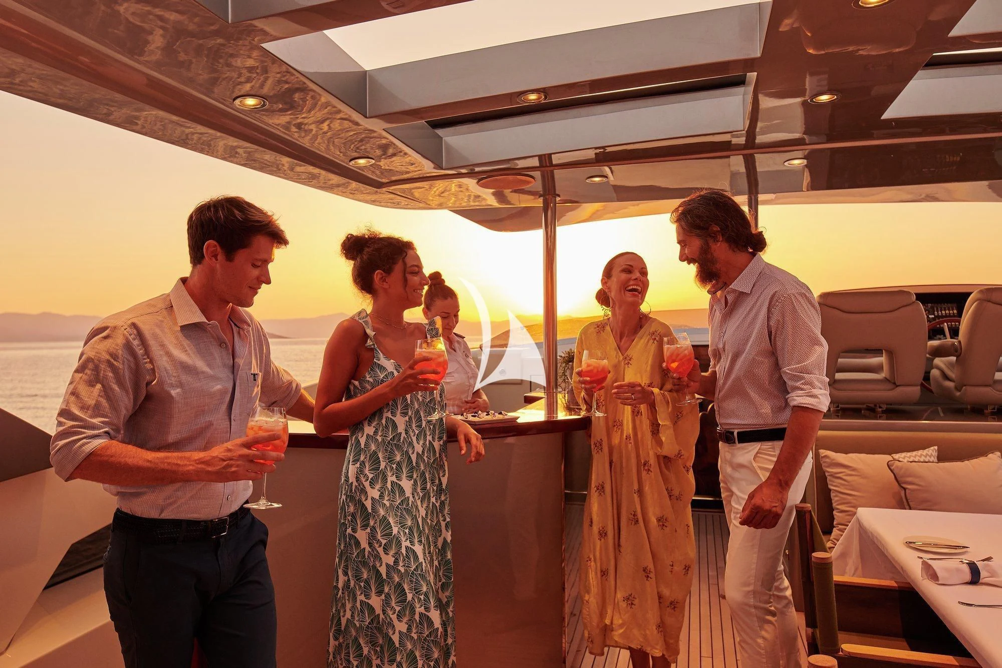 a group of people standing in a room aboard APMONIA Yacht for Sale