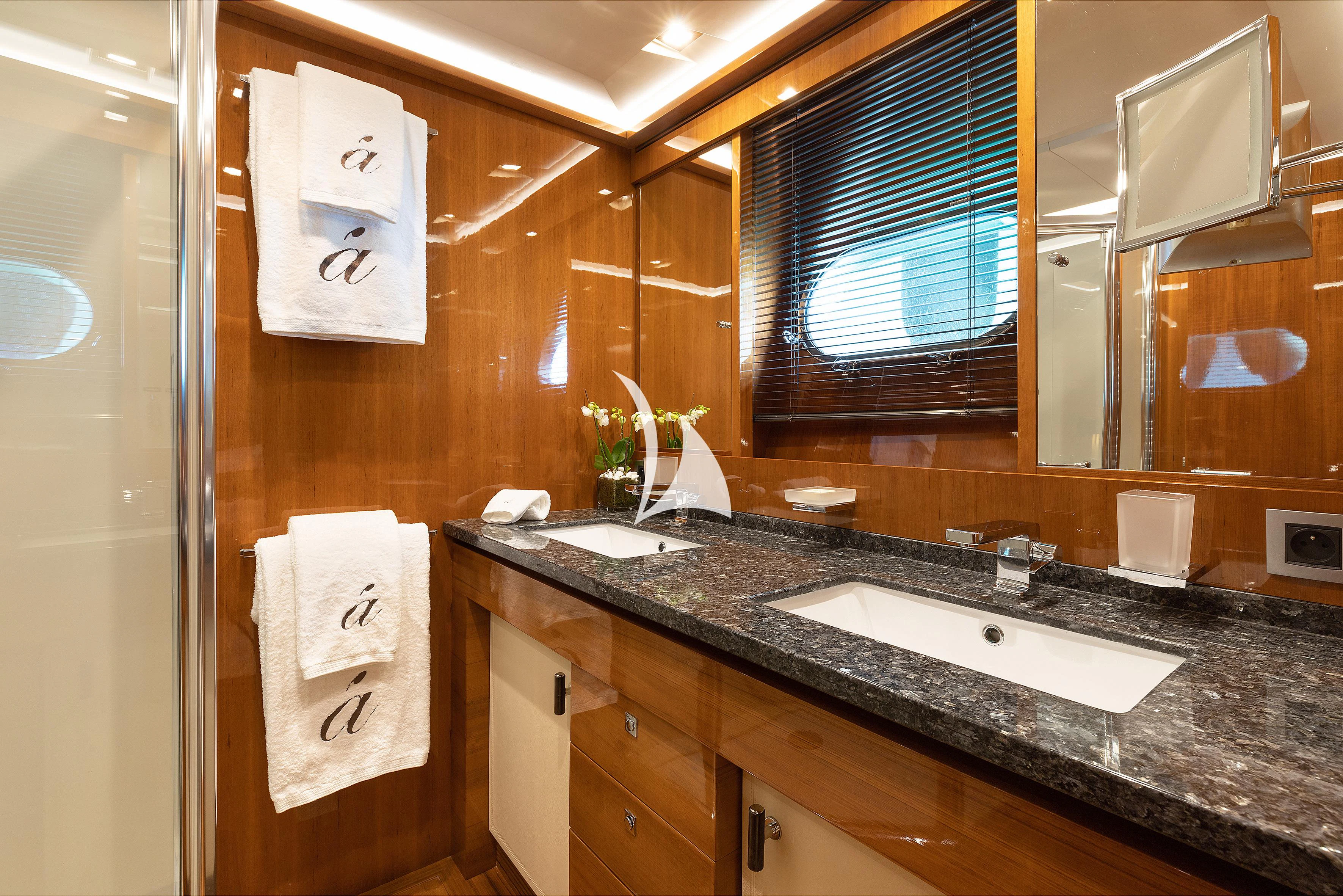 a bathroom with a sink and a mirror aboard APMONIA Yacht for Sale