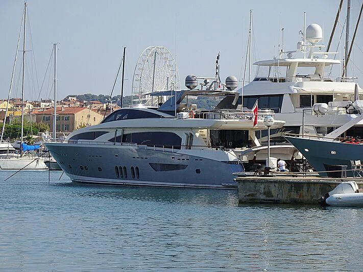 a couple of boats are parked at a dock aboard APMONIA Yacht for Sale