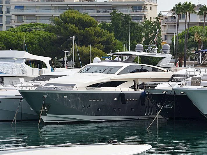 several boats docked at a pier aboard APMONIA Yacht for Sale