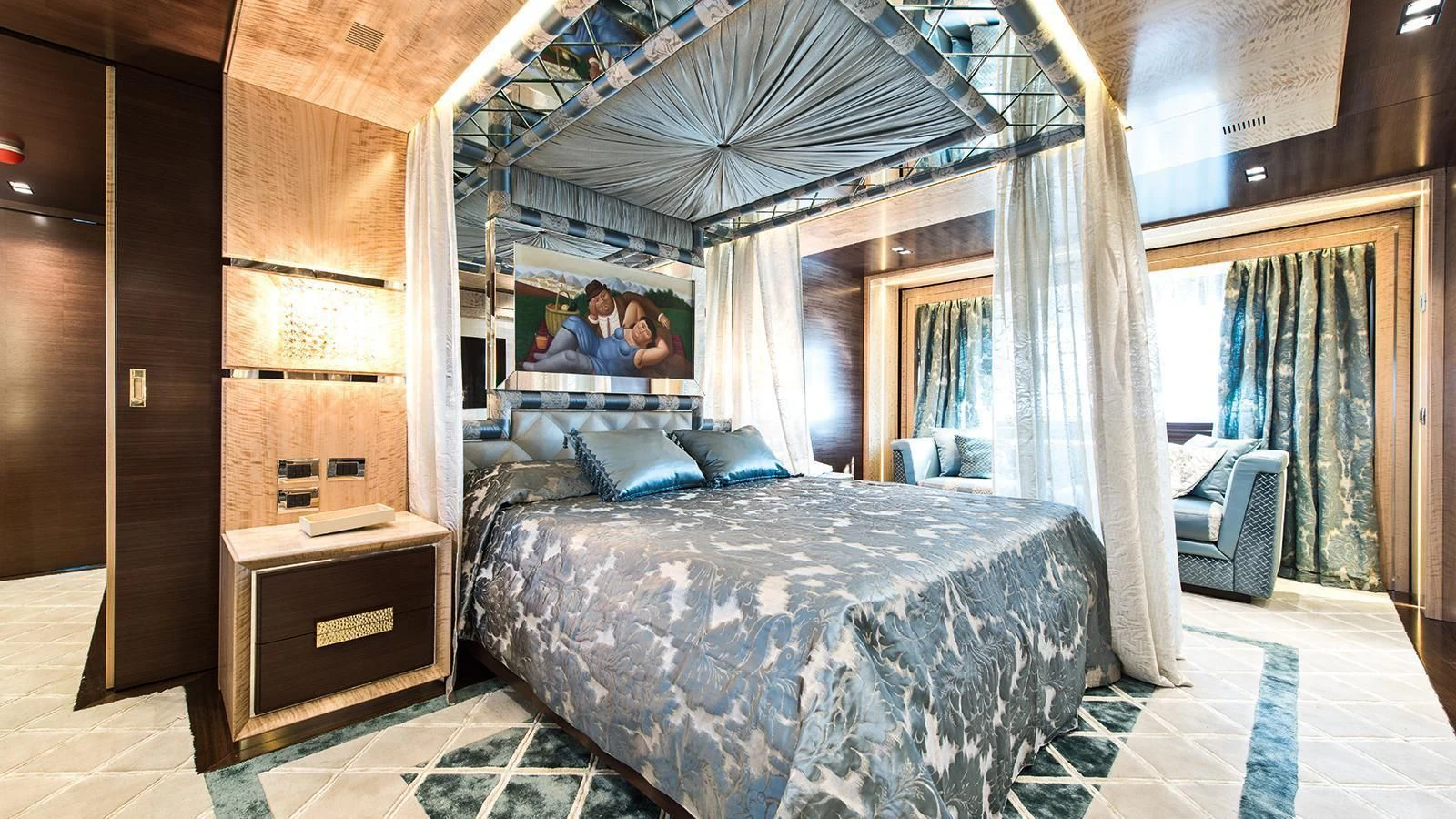 a couple of people sitting in a room with a bed aboard MODUS Yacht for Sale