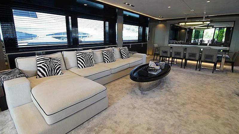 a living room with a couch and a table aboard MODUS Yacht for Sale