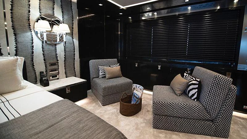 a room with a bed and a chair aboard MODUS Yacht for Sale
