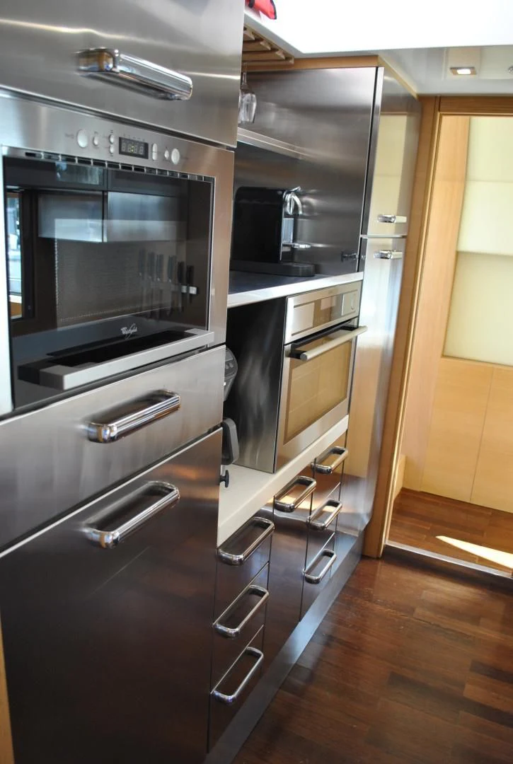 a kitchen with stainless steel appliances aboard KRYSKAR Yacht for Sale