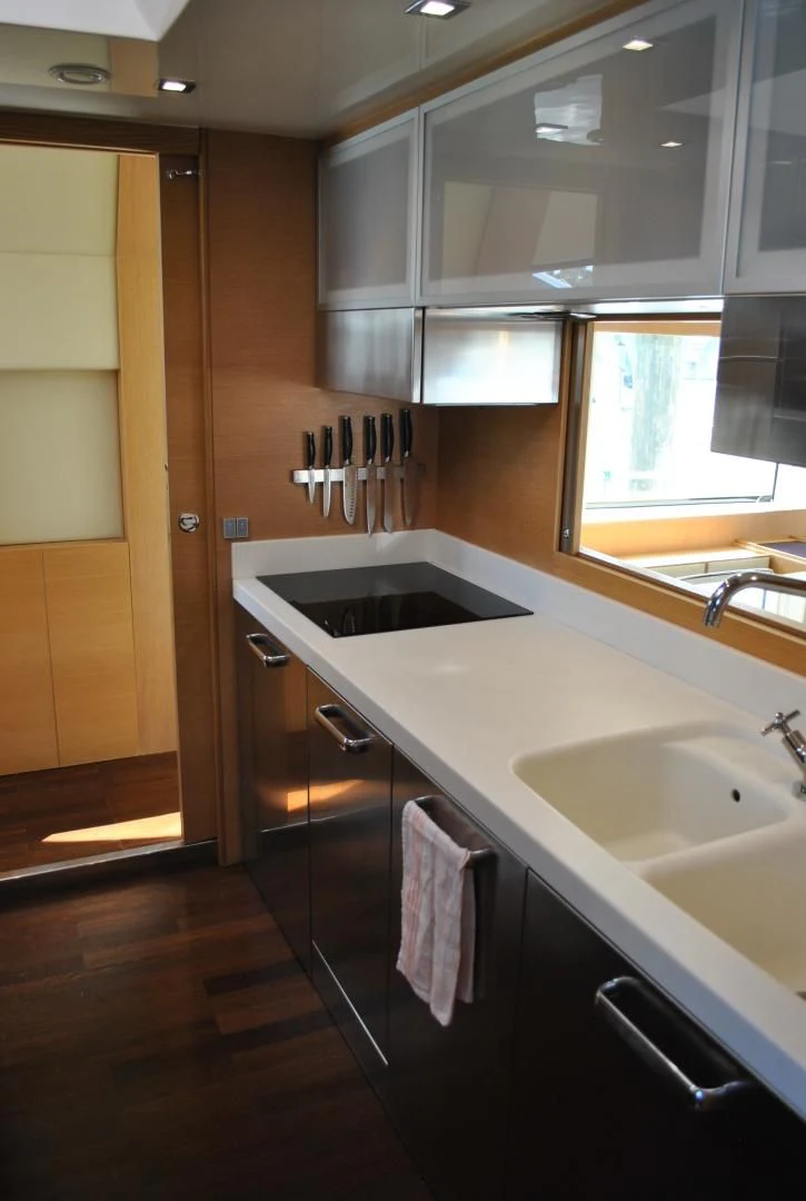 a kitchen with a sink and cabinets aboard KRYSKAR Yacht for Sale