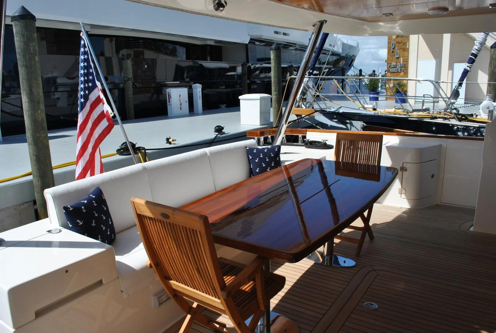 a table with chairs and a flag aboard KRYSKAR Yacht for Sale