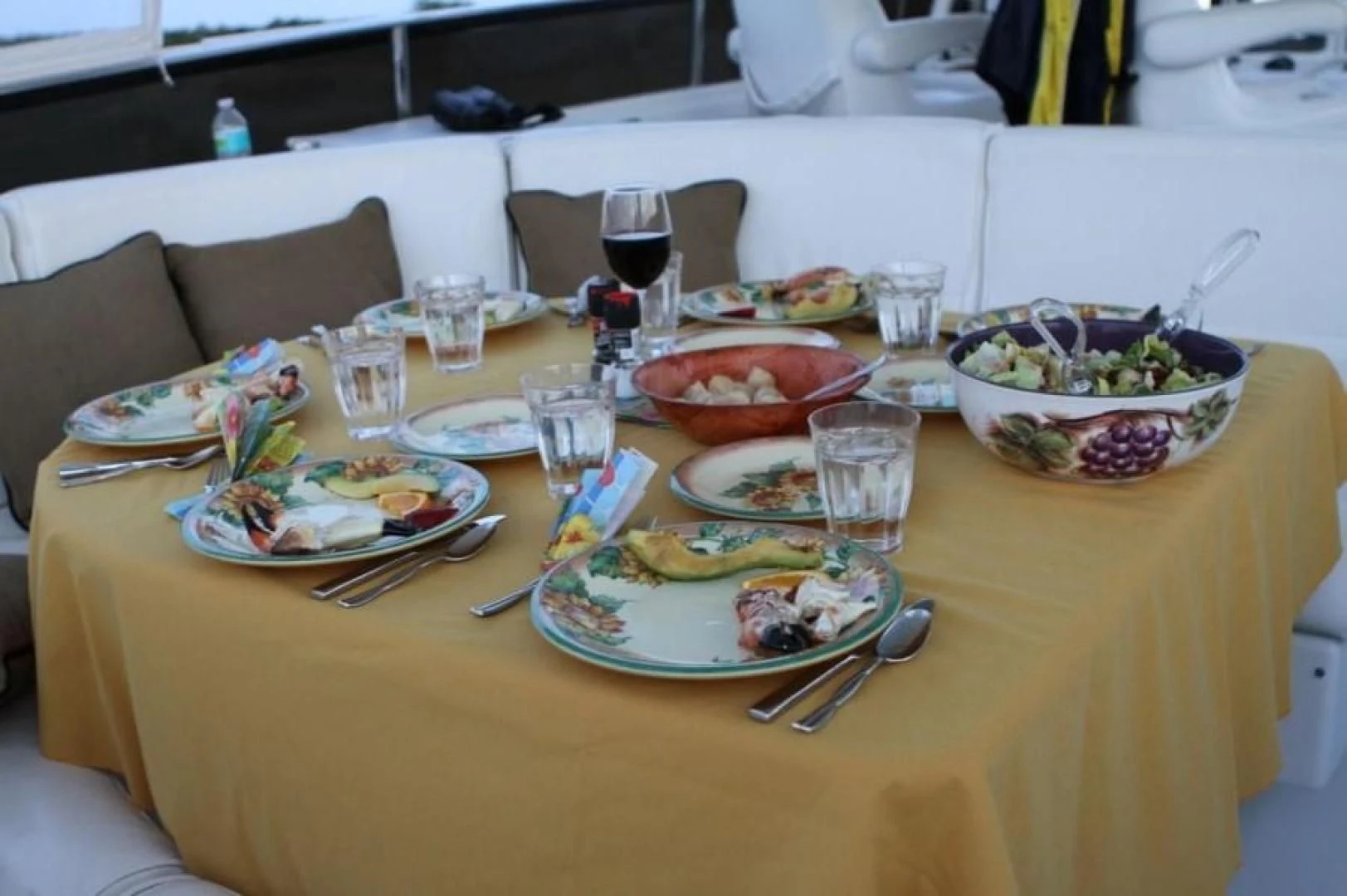 a table with plates and bowls of food on it aboard COMPANIONSHIP Yacht for Sale