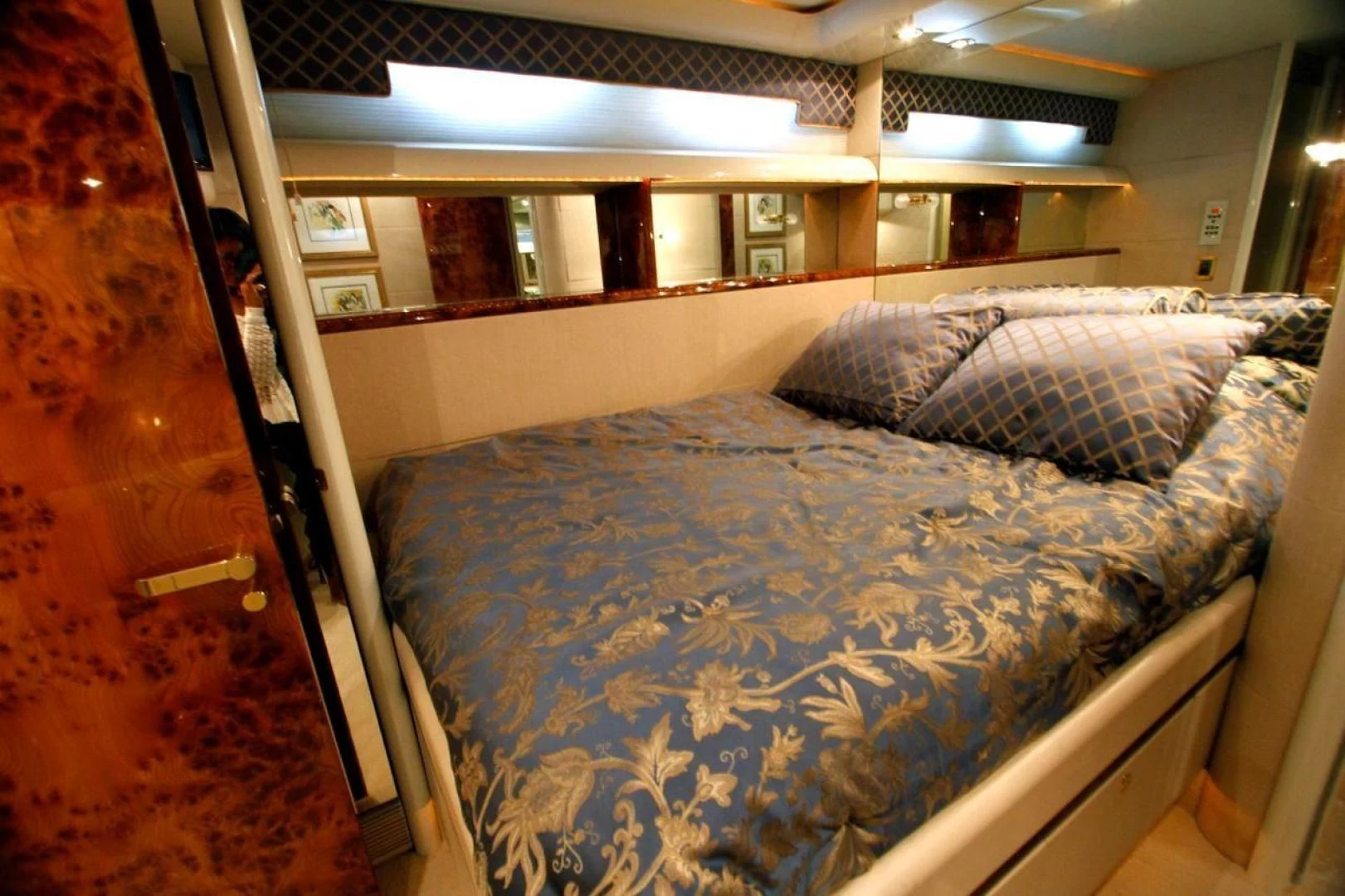 a bed with blue sheets aboard COMPANIONSHIP Yacht for Sale