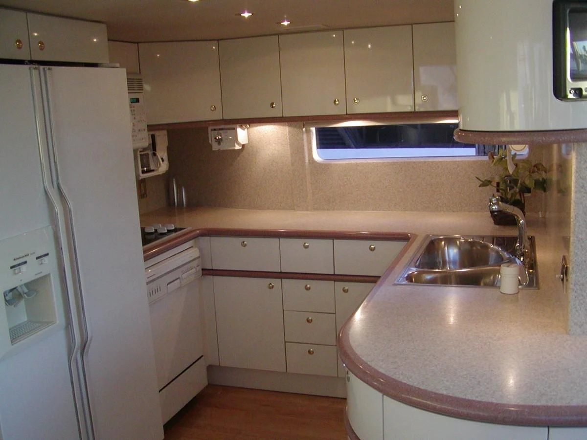a kitchen with a sink and refrigerator aboard COMPANIONSHIP Yacht for Sale