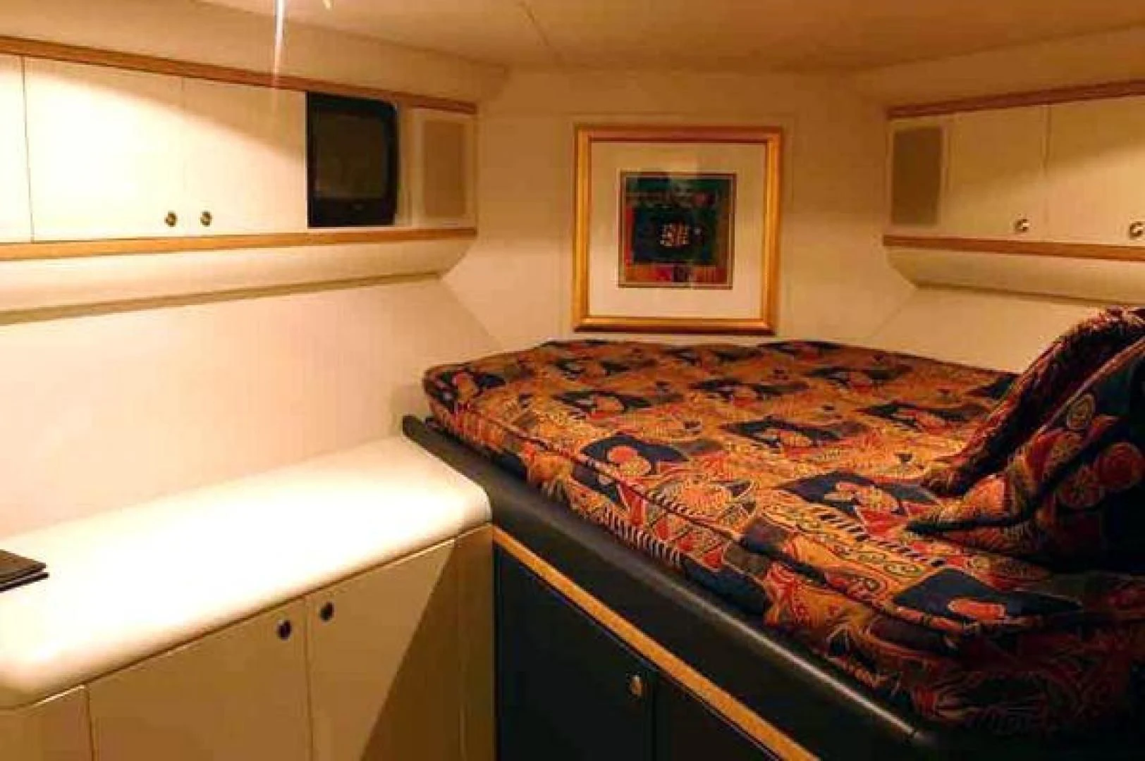 a bed with a colorful blanket aboard COMPANIONSHIP Yacht for Sale