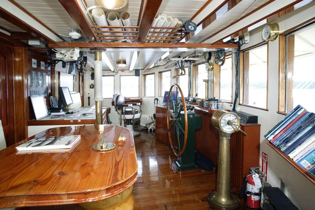 a room with a table and chairs aboard PACIFIC YELLOWFIN Yacht for Sale