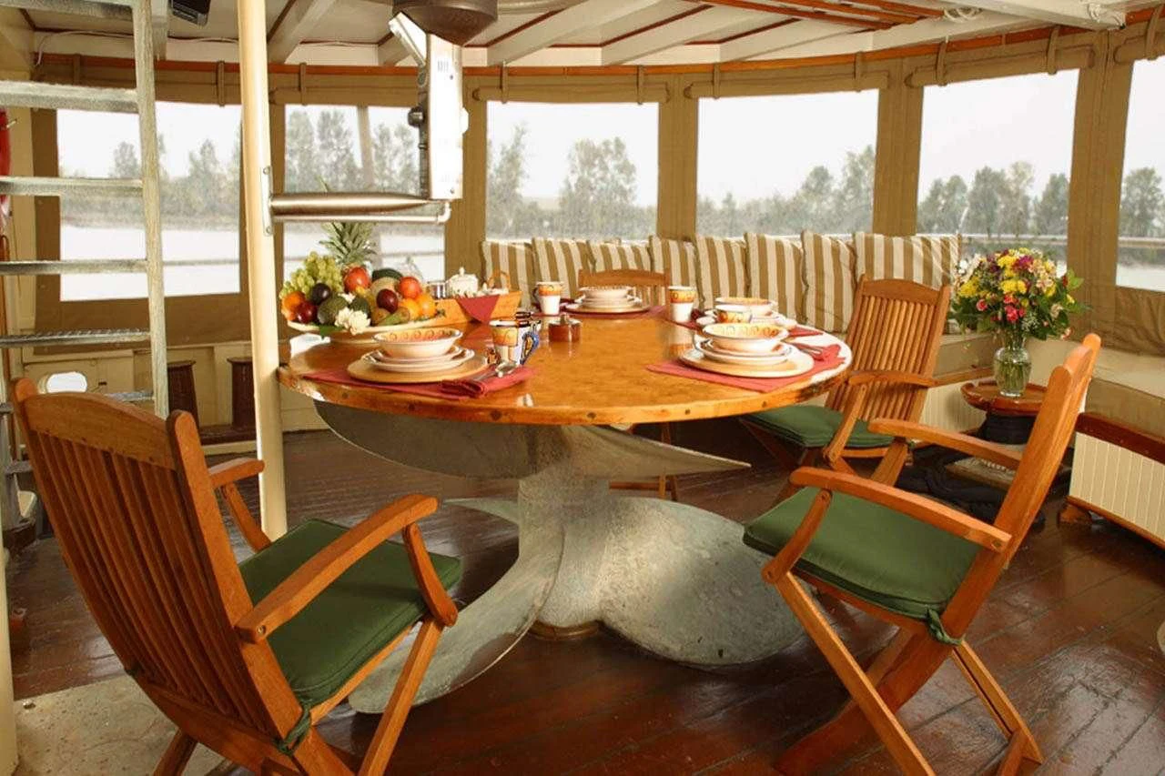 a table with chairs and a table aboard PACIFIC YELLOWFIN Yacht for Sale