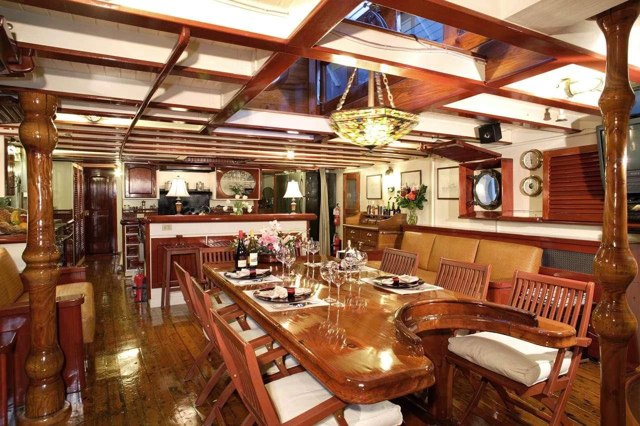 a dining room with a table and chairs aboard PACIFIC YELLOWFIN Yacht for Sale