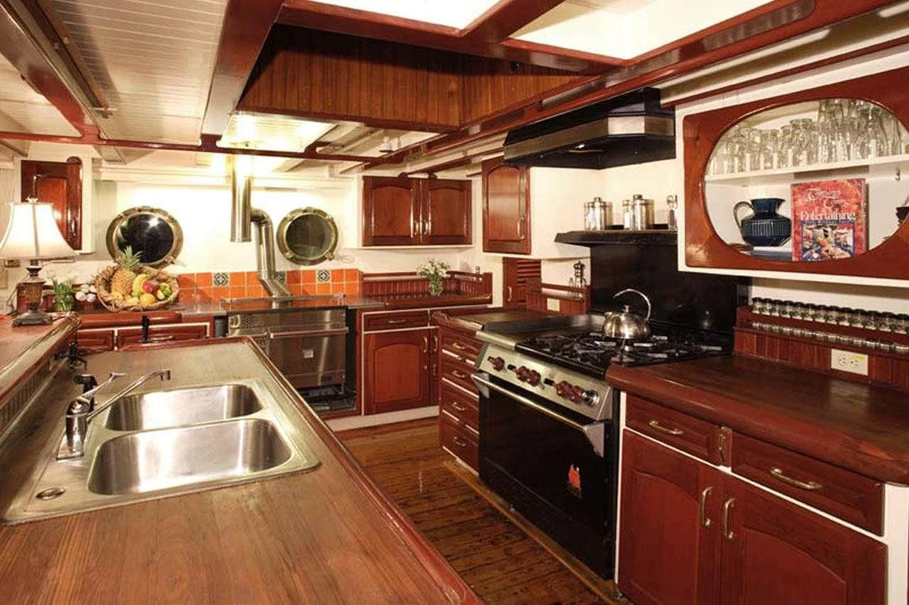 a kitchen with wooden cabinets aboard PACIFIC YELLOWFIN Yacht for Sale