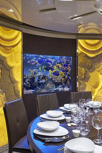 a large aquarium tank in a restaurant aboard BELLA ITALIA Yacht for Sale