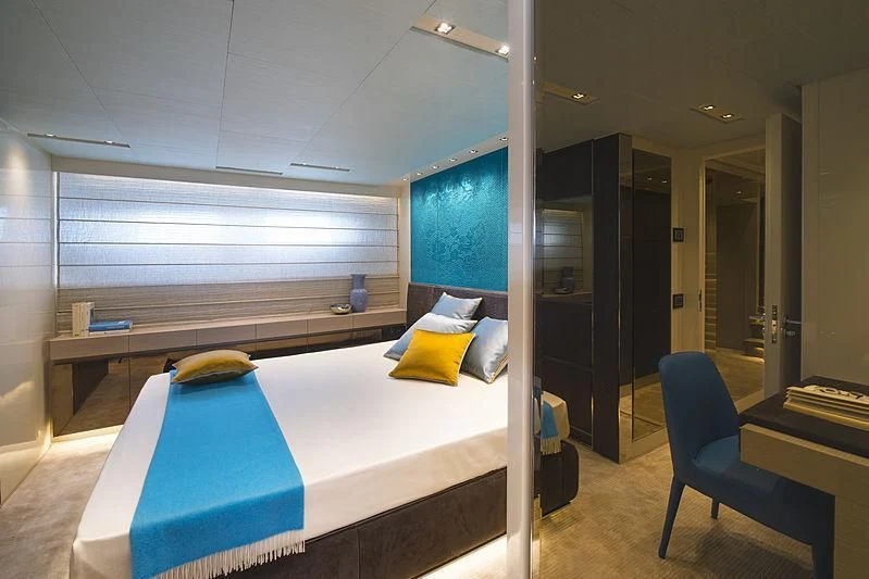 a room with a bed and a chair aboard BELLA ITALIA Yacht for Sale