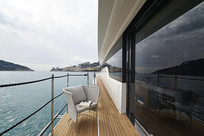 a deck with a view of the ocean and the city below aboard BELLA ITALIA Yacht for Sale