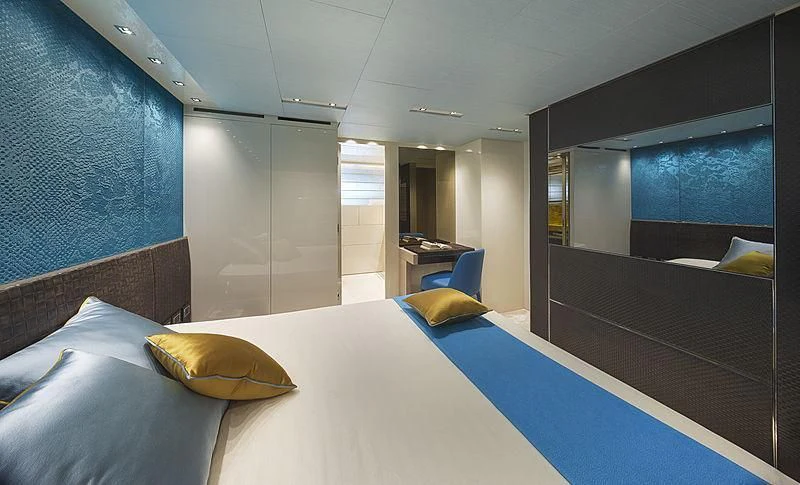 a room with a bed and a mirror aboard BELLA ITALIA Yacht for Sale