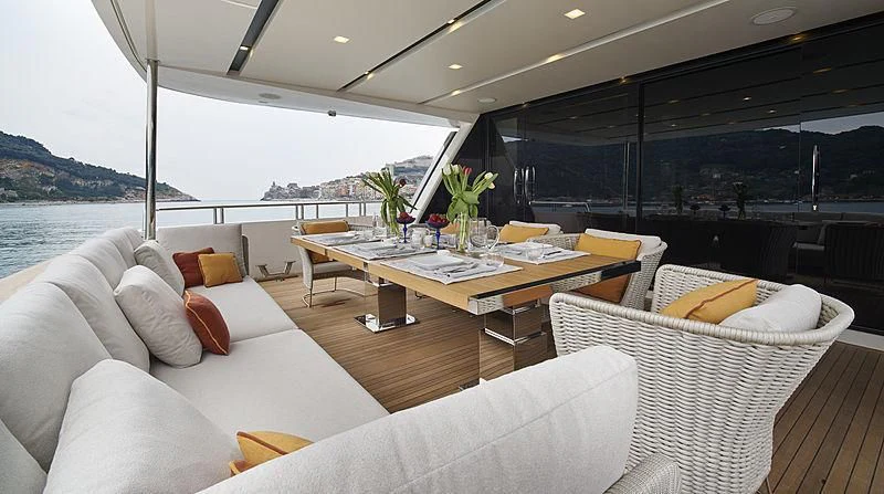 a room with couches and a table and chairs aboard BELLA ITALIA Yacht for Sale
