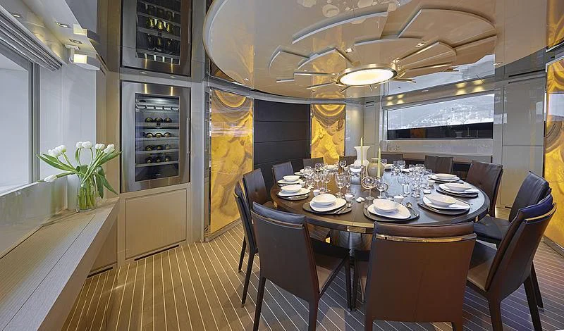 a dining room with a table set for dinner aboard BELLA ITALIA Yacht for Sale