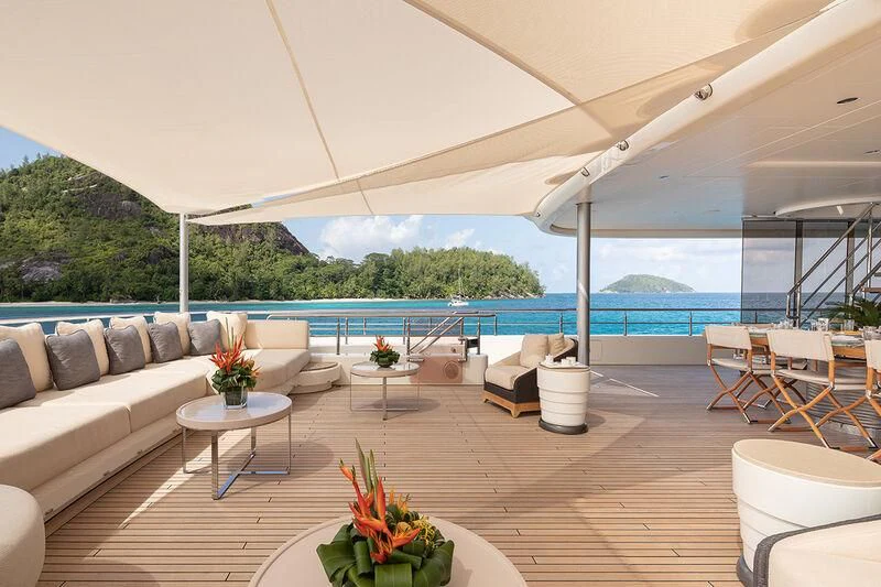 a patio with tables and chairs aboard ROMEA Yacht for Sale