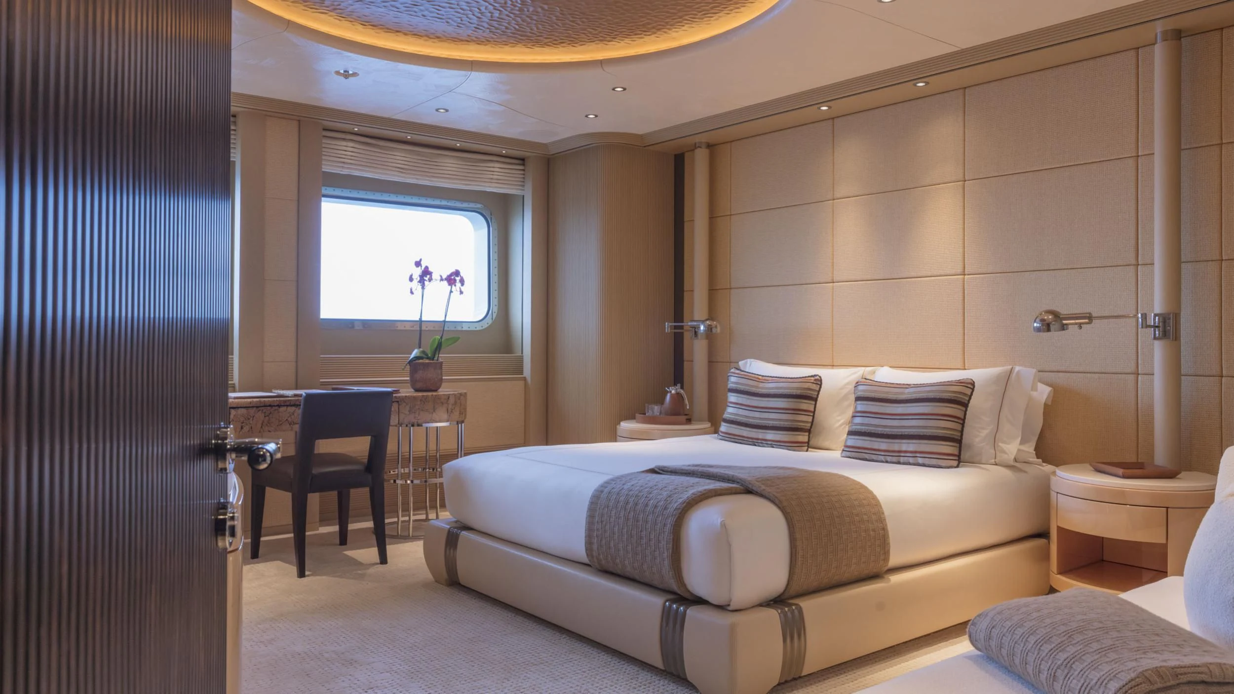 a room with a bed and a chair aboard ROMEA Yacht for Sale