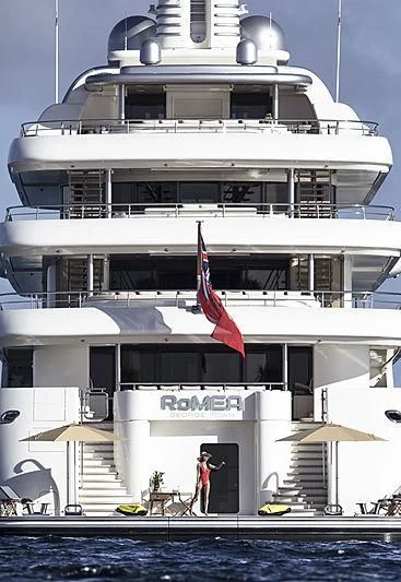 a large white building with a flag on the front aboard ROMEA Yacht for Sale