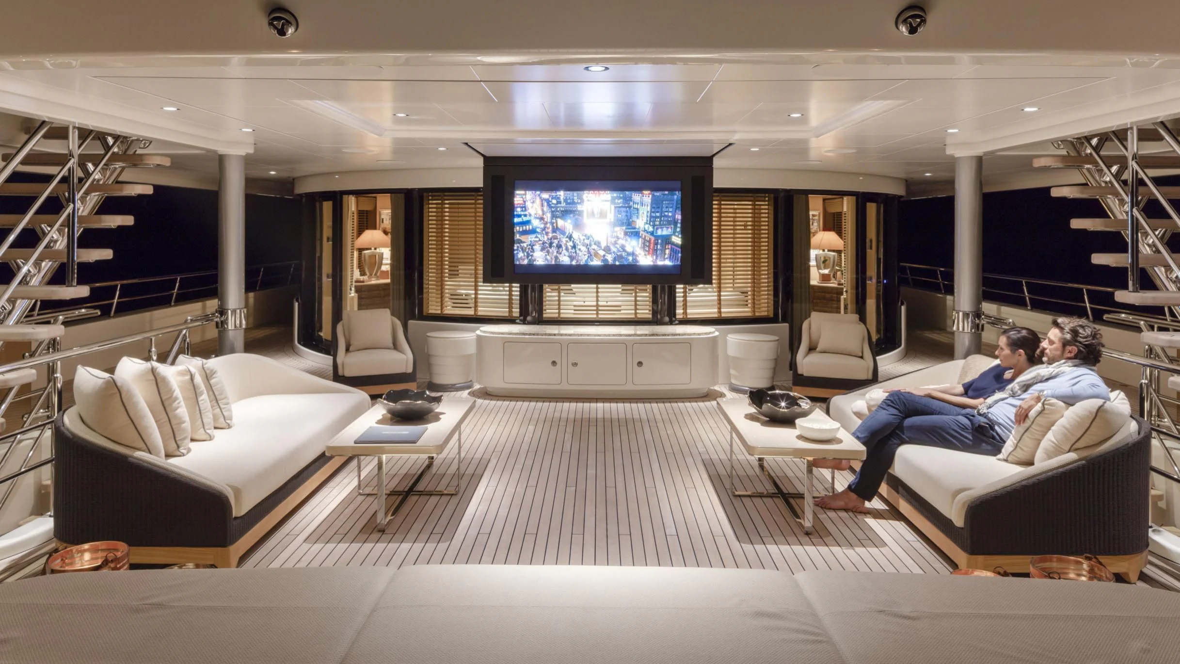 a couple of people sitting on a couch watching tv aboard ROMEA Yacht for Sale