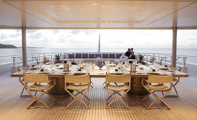 a room with tables and chairs aboard ROMEA Yacht for Sale