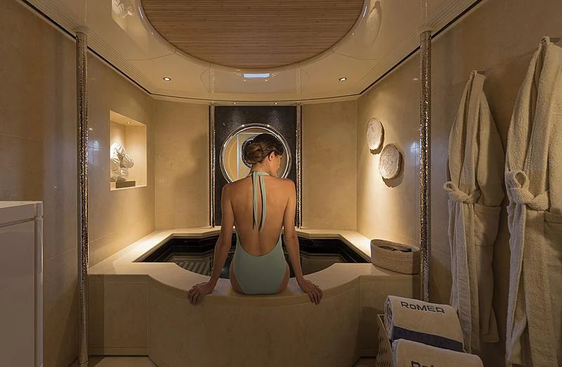 a person sitting on a bed aboard ROMEA Yacht for Sale