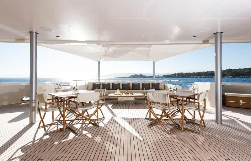 a room with a table and chairs aboard ROMEA Yacht for Sale