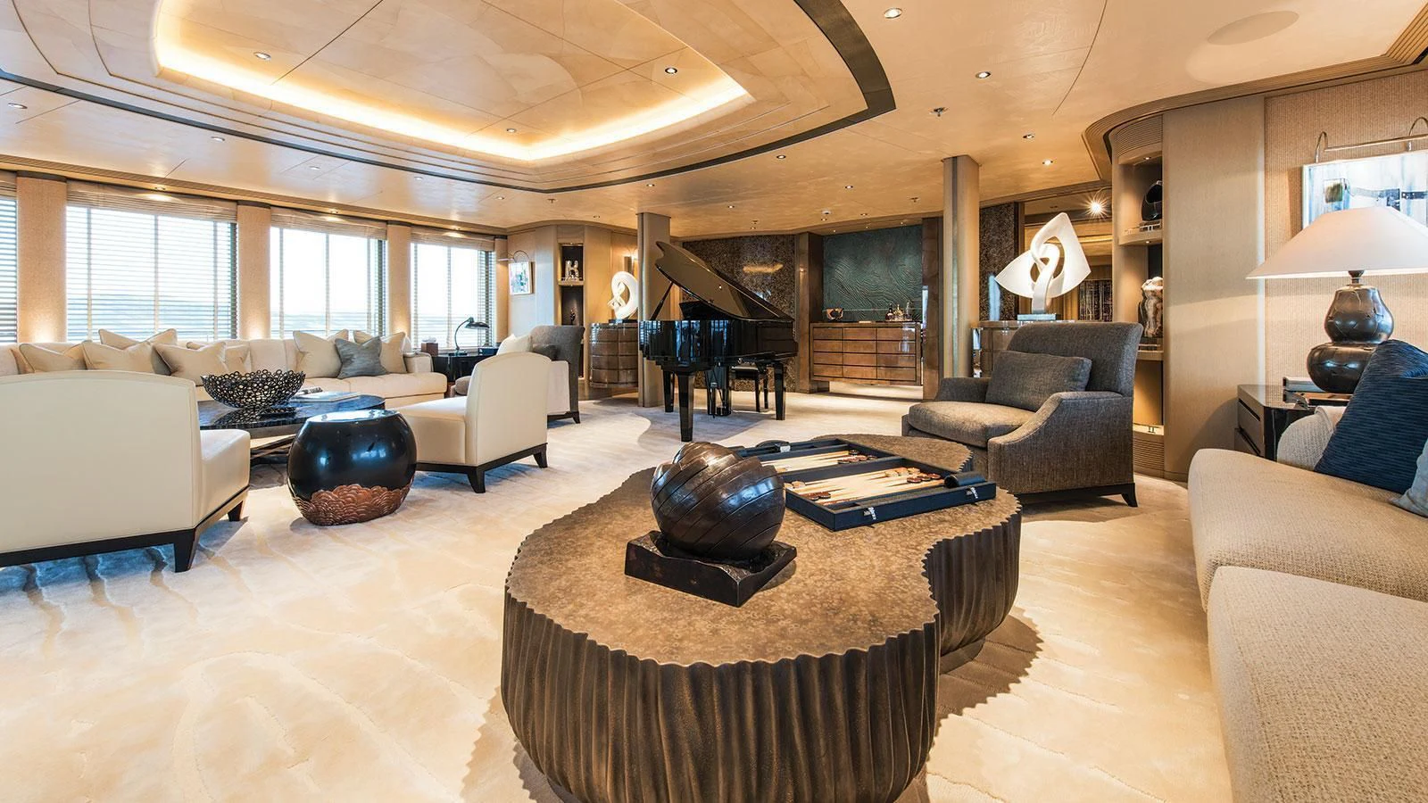 a large living room with a large fireplace aboard ROMEA Yacht for Sale